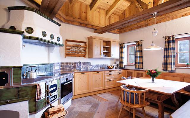 Spacious eat-in kitchen with high-quality electrical appliances and tiled stove