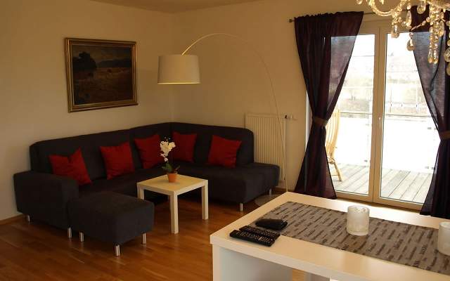 Living room with cozy couch and view of Lake Faak