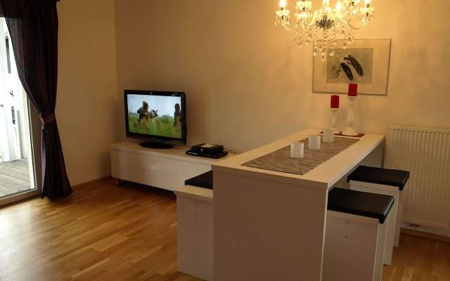 Living room with dining table, flat-screen TV and balcony