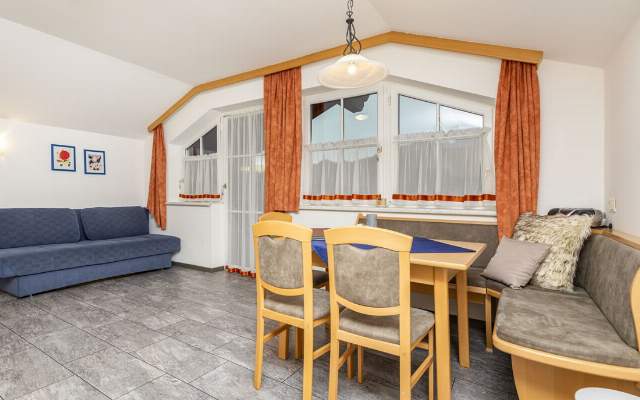 Living room with dining table and flat-screen TV