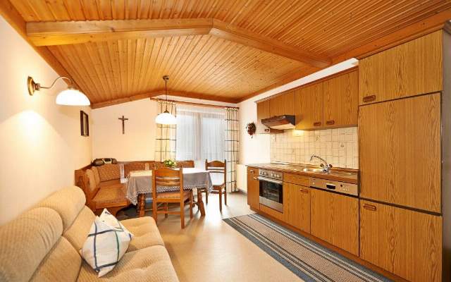 Spacious kitchen-living room with dining table and balcony