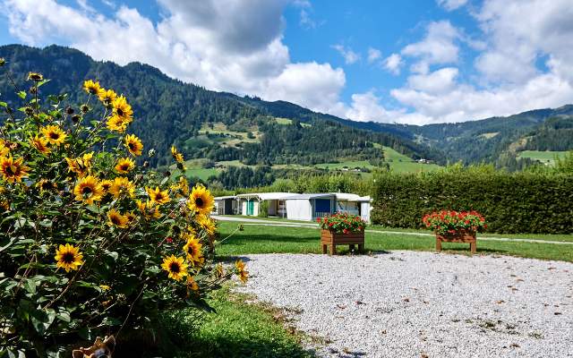 Shady places for caravans, motorhomes or tents. Wellness possible in the main house