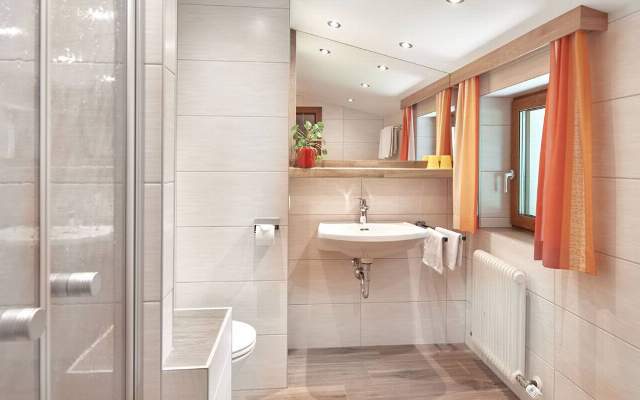 Spacious bathroom with shower and toilet