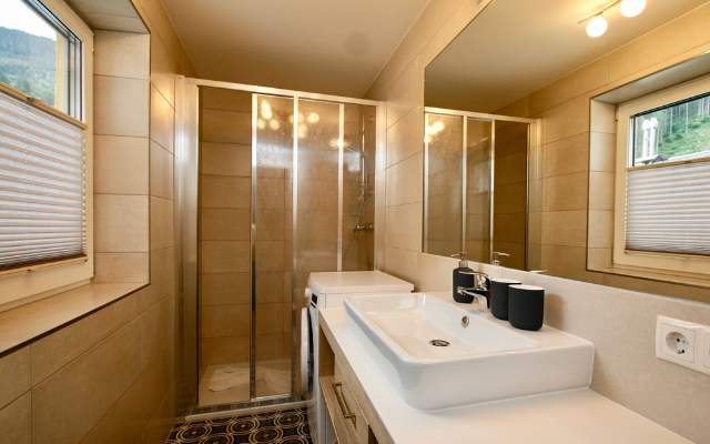 Bathroom with sink, washing machine and shower