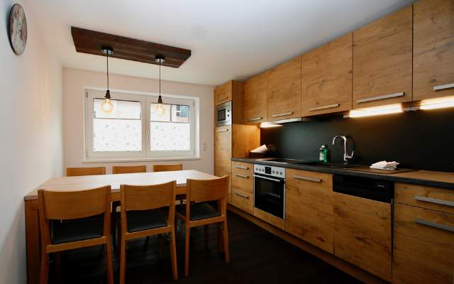 Large kitchen with high-quality electrical appliances and dining table